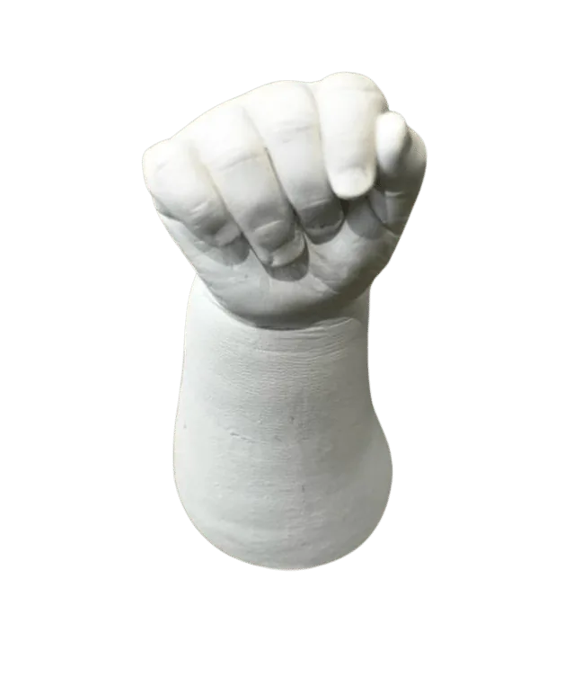 White plaster cast molding of a baby's clenched fist and wrist.